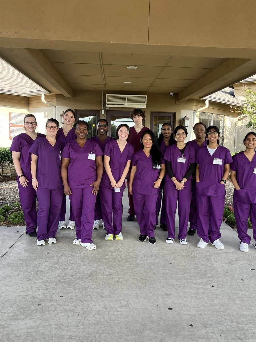 Cohort in scrubs gathered outside the academy