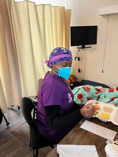 Clinical skills practice in purple scrubs