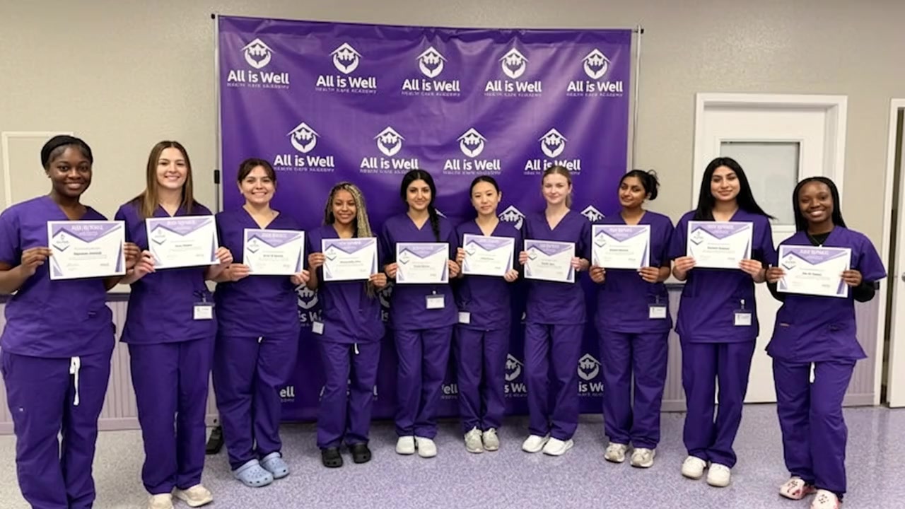 An All is Well Health Care Academy graduating class holding their certificates
